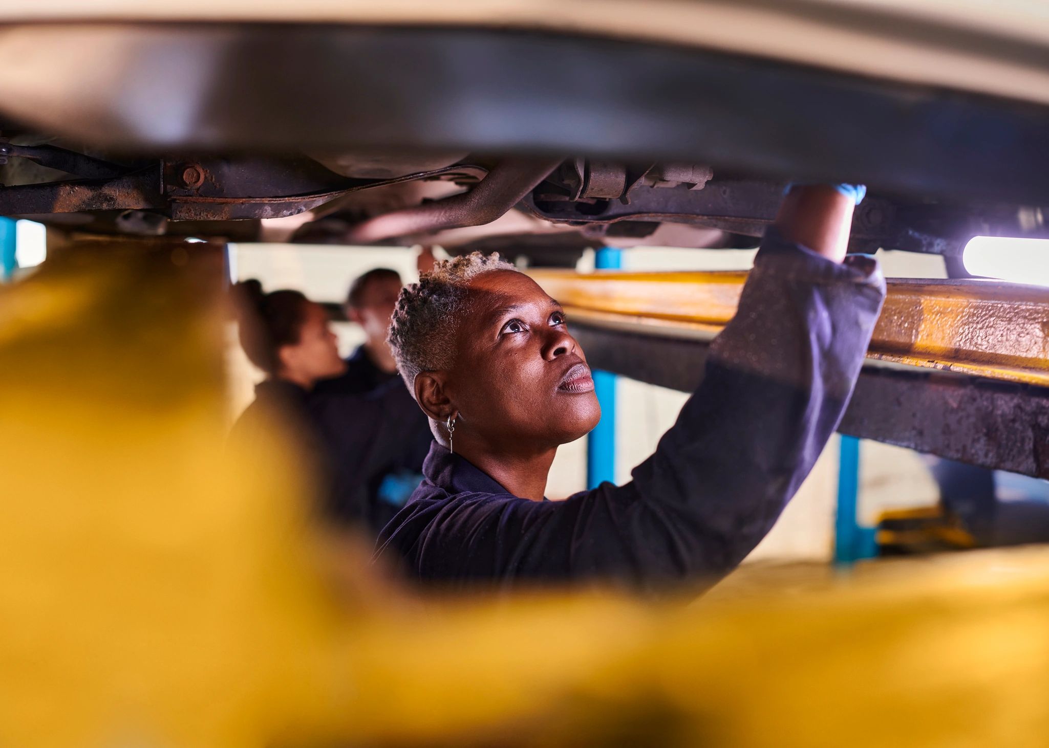 Mechanic performing vehicle checks in a workshop