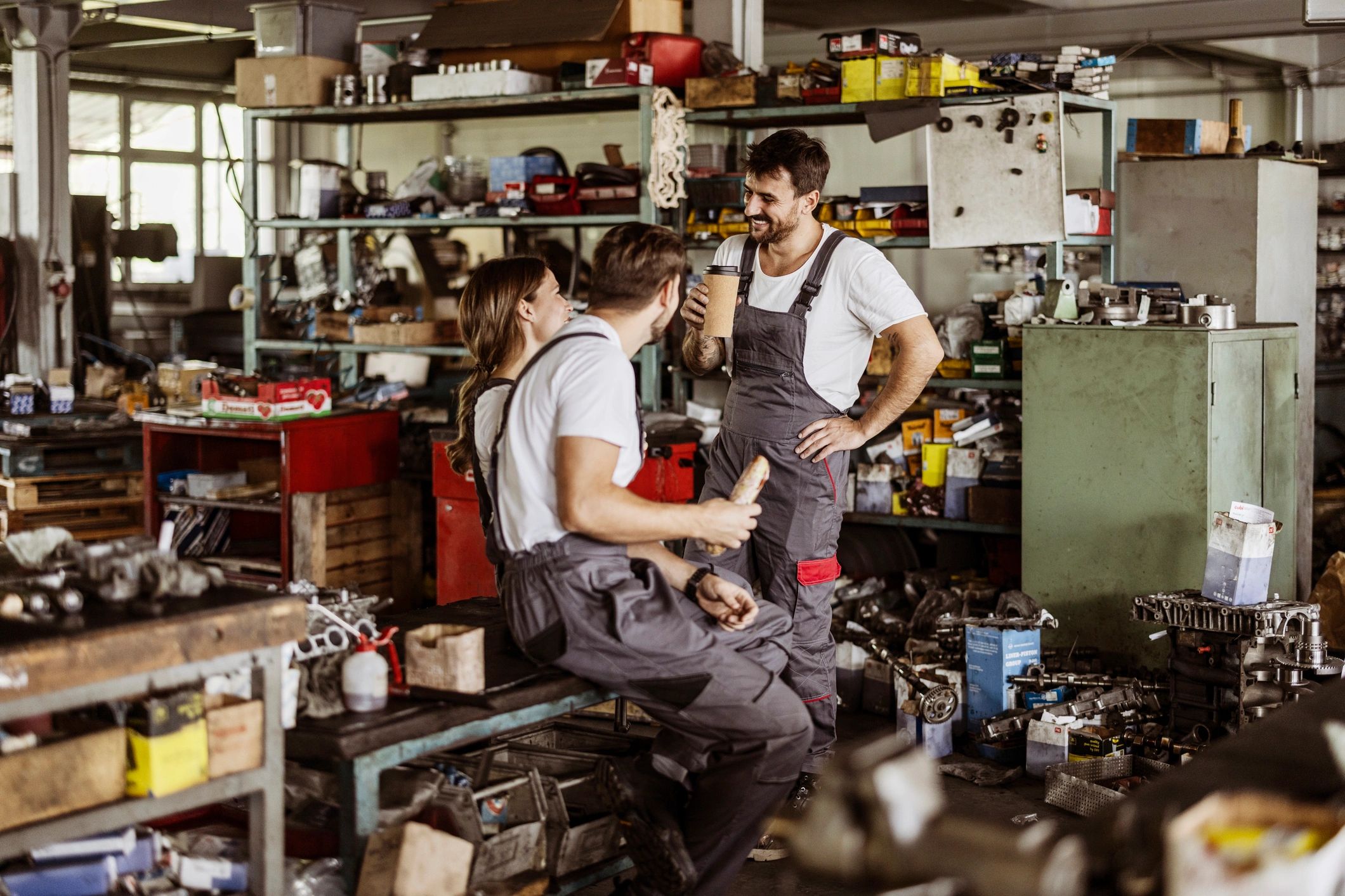 Two workshop workers smiling during a break