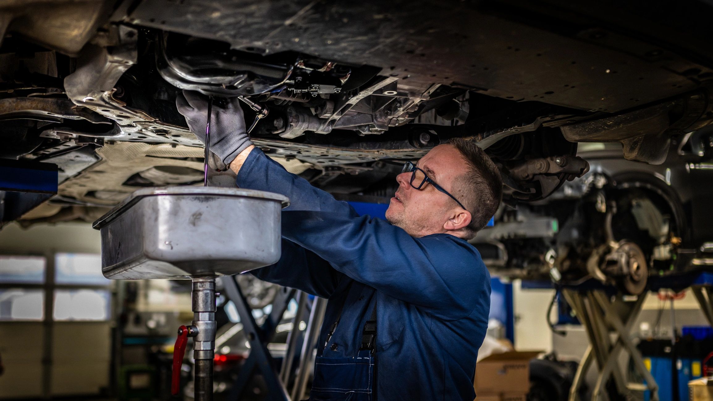 Mechanic servicing a vehicle in a workshop